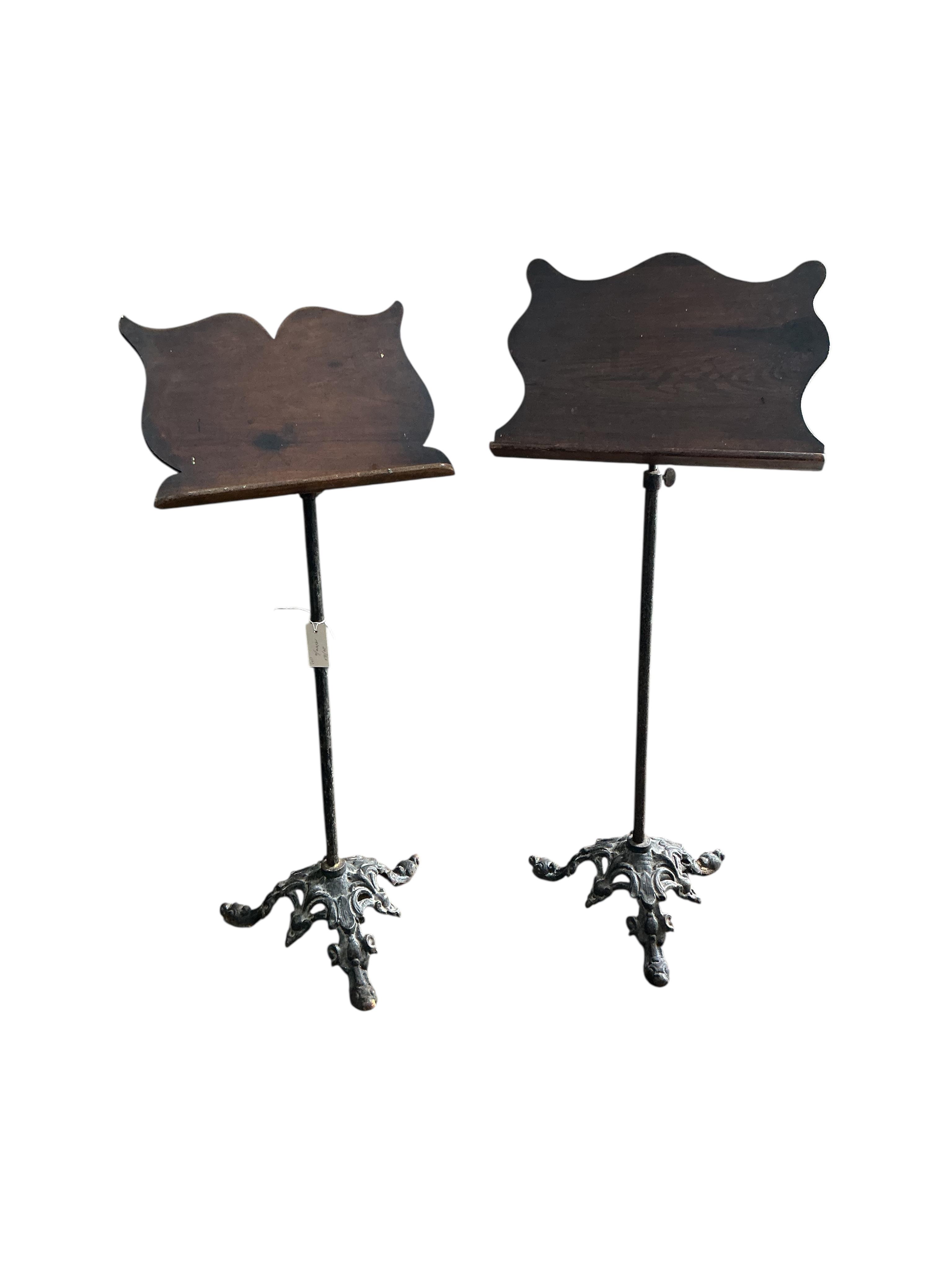 A pair of Victorian and later cast iron pine and mahogany music stands, height 112cm